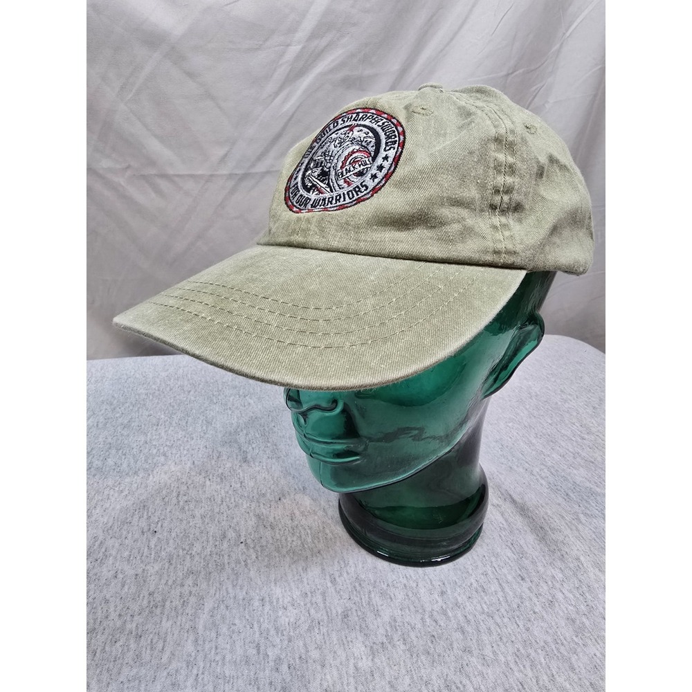 tan-colored distressed baseball hat patch "We‎ Build Sharper Swords For Our...